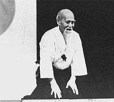 髭の生えた袴の年配男性が正座しているモノクロ写真