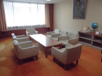 部屋の中央のテーブルを囲んでソファが置かれている写真