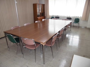 テーブルとそれを囲んで椅子が備えられている部屋の写真