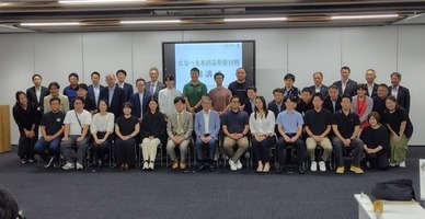 出席者たちが前後に分かれて整列し、正面を向いている写真